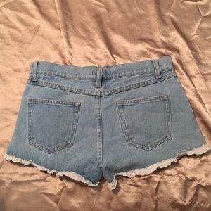 Lace fringed denim shorts